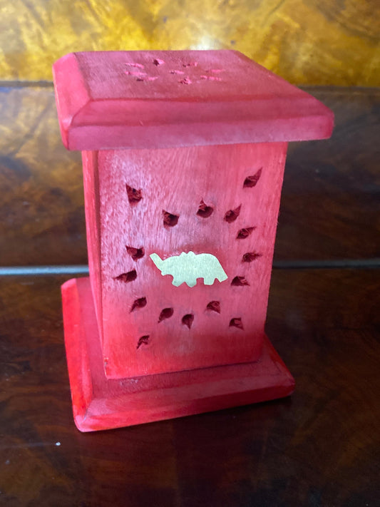 red incense holder with gold elephant 