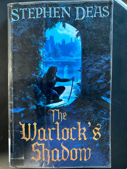 The Warlock's Shadow book by Stephen Deas, featuring a dark fantasy cover with a hooded figure in a blue-lit archway scene.