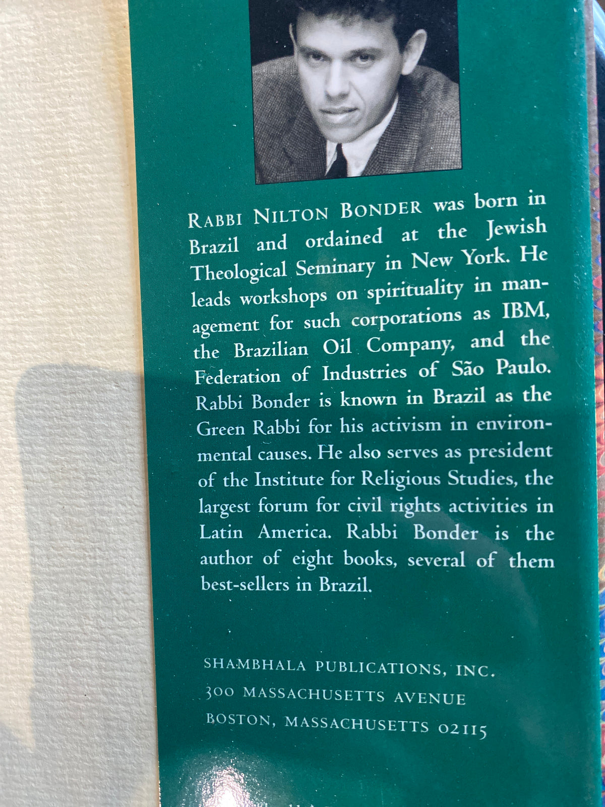 The back cover of a book featuring a teal background with a black-and-white portrait of Rabbi Nilton Bonder at the top, followed by biographical text and publisher information at the bottom.