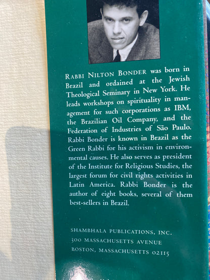 The back cover of a book featuring a teal background with a black-and-white portrait of Rabbi Nilton Bonder at the top, followed by biographical text and publisher information at the bottom.